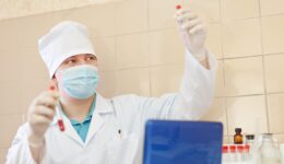 research worker with test tubes